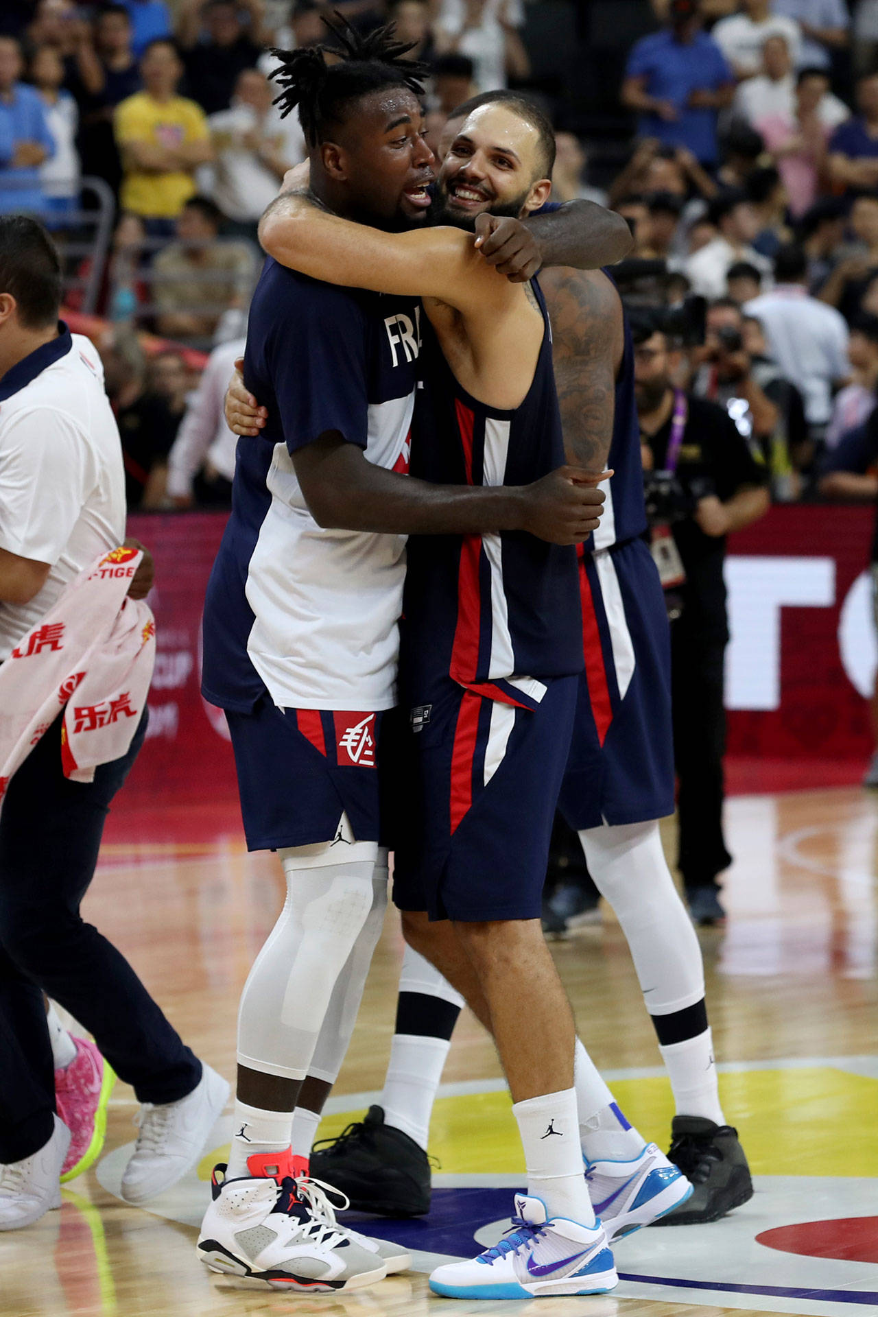 France’s Mathias Lessort (left) hugs teammate Evan Fournier as they celebrate their win over the United States on Wednesday at the FIBA Basketball World Cup in Dongguan, China. (AP Photo/Ng Han Guan)