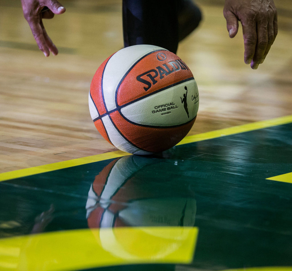 A referee reaches for the game ball during the game against the Minnesota Lynx on Wednesday, Sept. 11, 2019 in Everett, Wash. (Olivia Vanni / The Herald)
