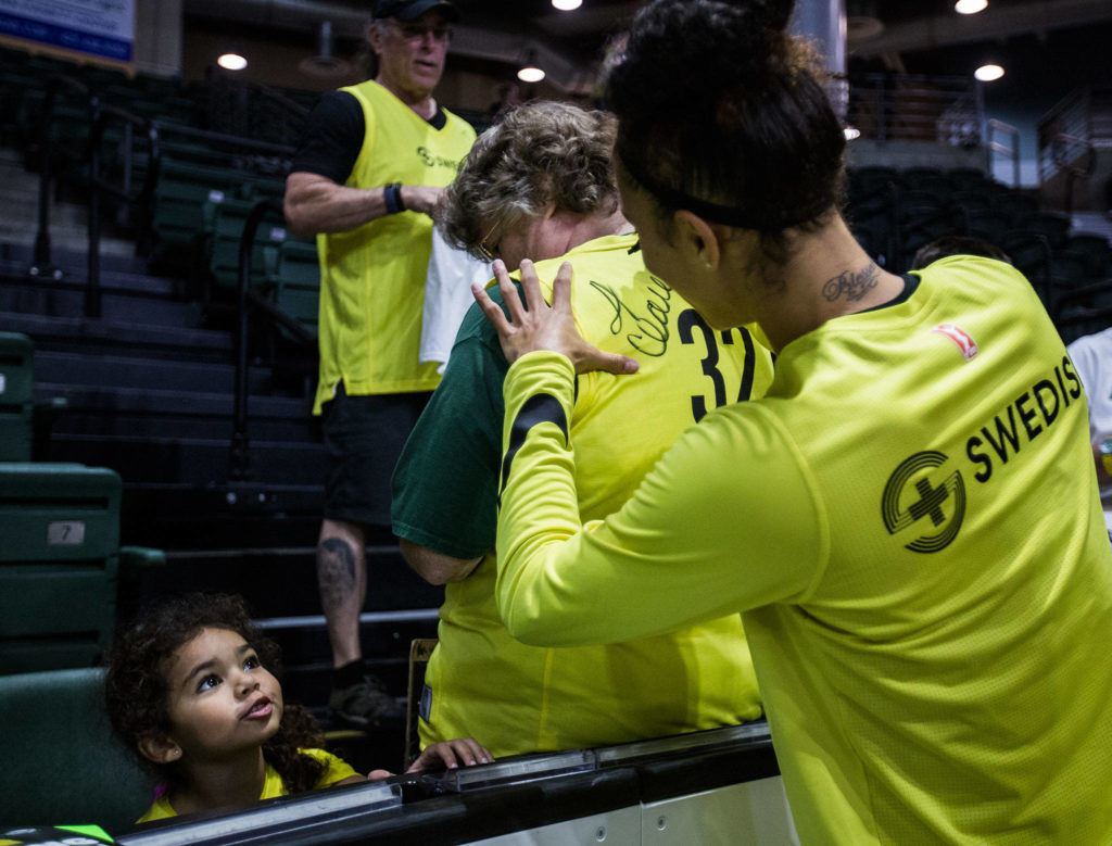 Regina Perlmutter, 4, left, looks up at Seattle Storm’s Alysha Clark as she signs autographs before the game against the Minnesota Lynx on Wednesday, Sept. 11, 2019 in Everett, Wash. (Olivia Vanni / The Herald)