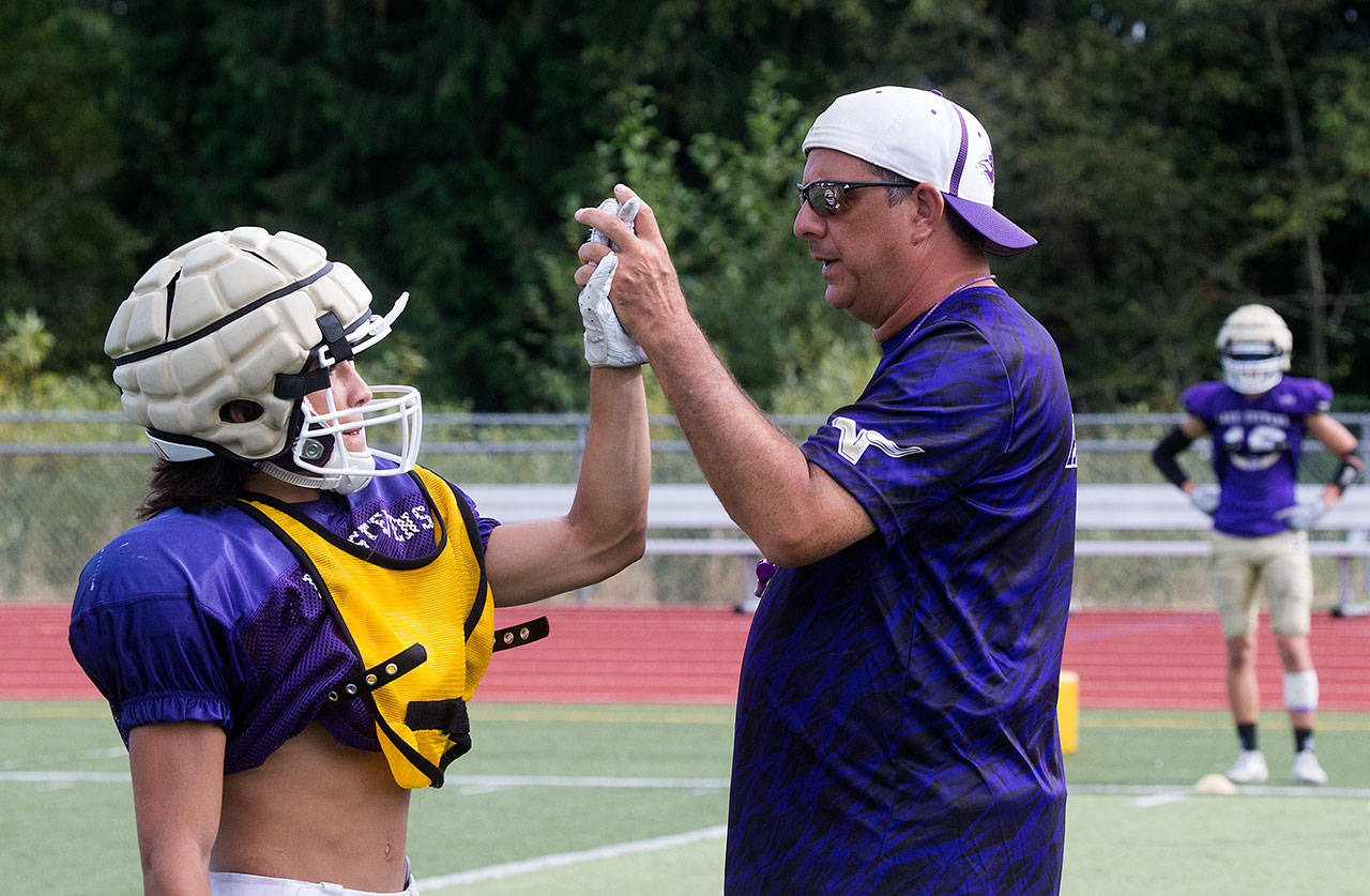 Lake Stevens head football coach Tom Tri congratulates one of his players during a practice in August. (Andy Bronson / The Herald)