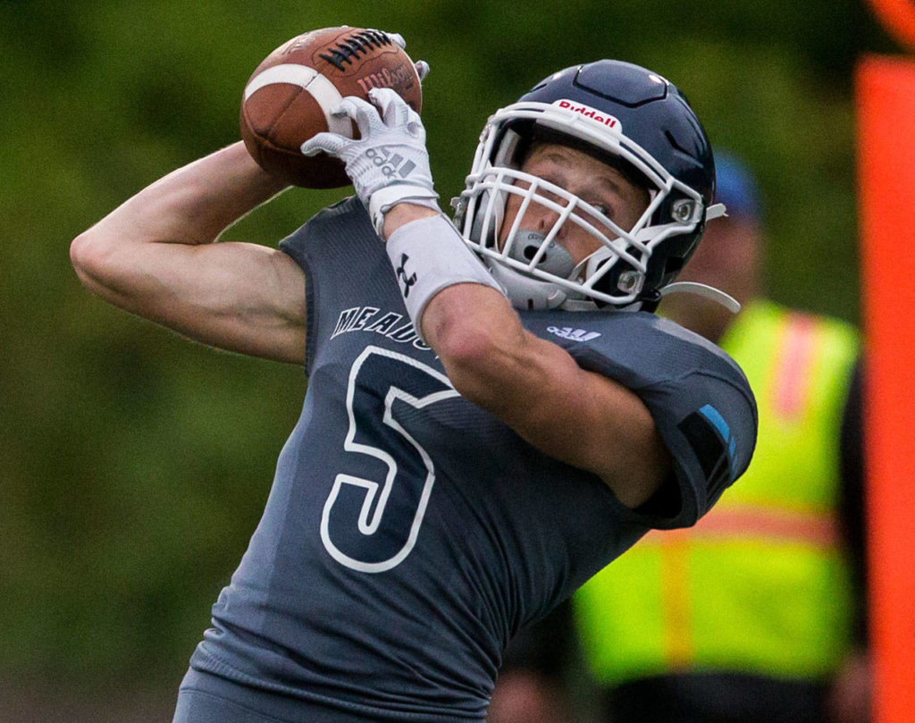 Meadowdale’s Kristian Lunsford makes a catch and runs in the ball for a touchdown during a game against Shorewood on Sept. 13, 2019, at Edmonds Stadium. (Olivia Vanni / The Herald)
