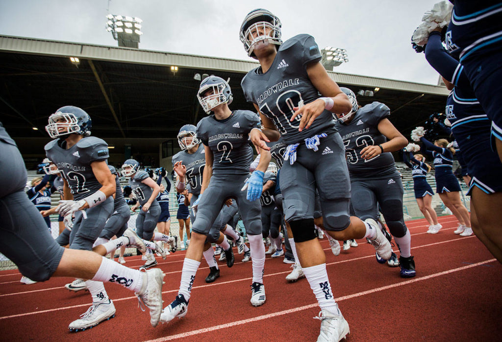 The Meadowvale team runs out on to the field before that start of a game against Shorewood on Sept. 13, 2019, at Edmonds Stadium. (Olivia Vanni / The Herald)
