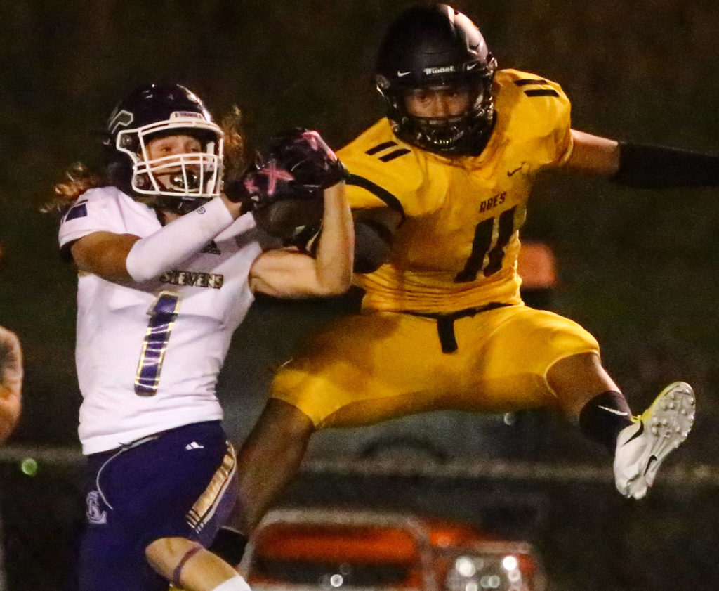 Lake Stevens’ Gabe Ramsey (left) makes an interception on a pass intended for Lincoln’s Jasiah Snow-Marshall during a game on Sept. 13, 2019, at Lincoln Bowl in Tacoma. Lake Stevens won 35-26. (Kevin Clark / The Herald)
