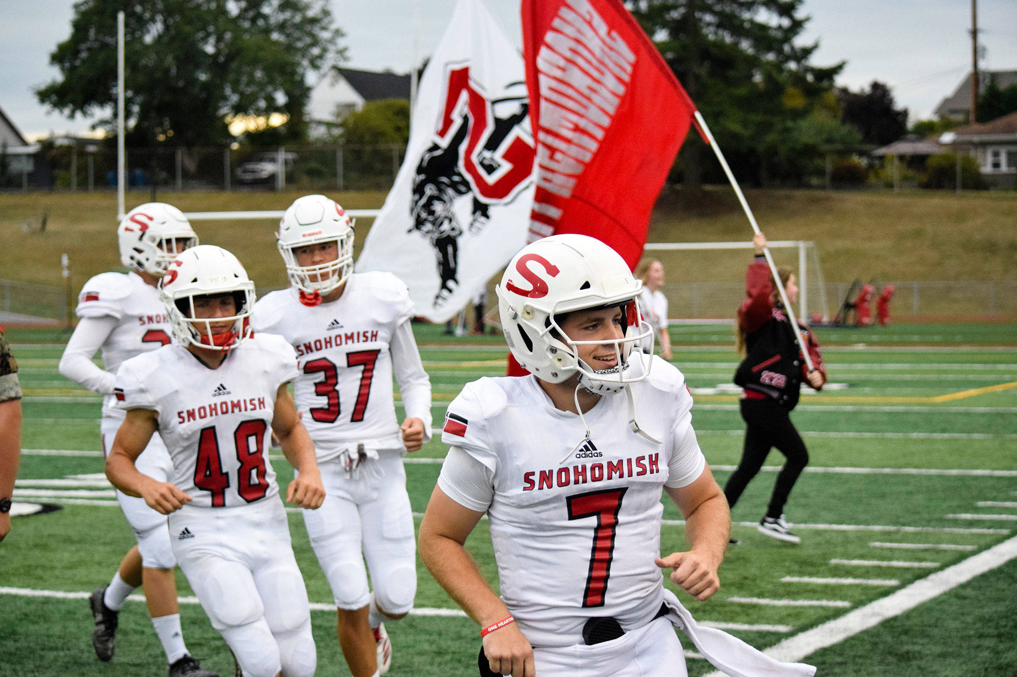 Senior Kyler Hammer leads the team onto the field before the game against Glacier Peak on Friday, Sept. 13 at Veterans Memorial Stadium. (Katie Webber / The Herald)