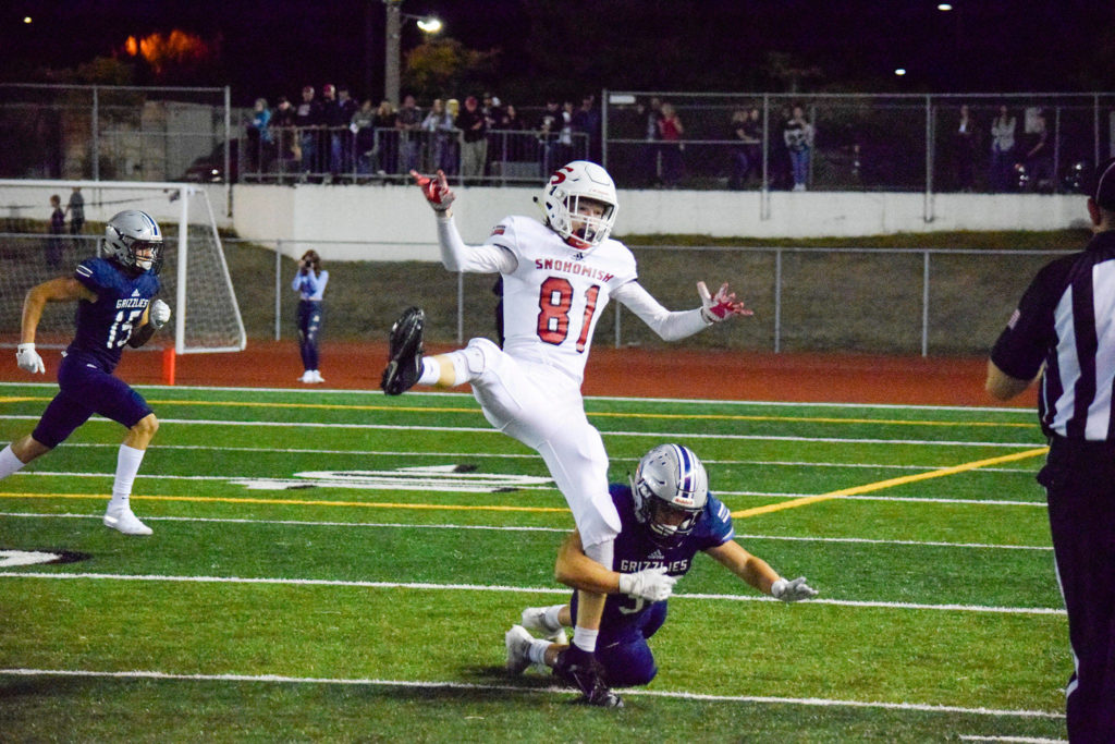 Senior wide receiver Blake Pesznecker falls while being tackled by a Glacier Peak defender on Friday, Sept. 13 at Veterans Memorial Stadium. (Katie Webber / The Herald)
