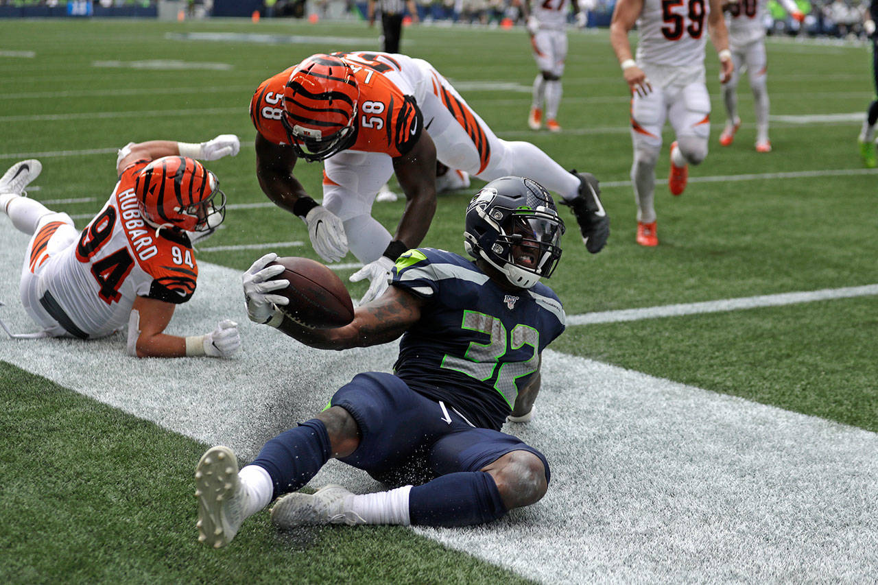 Seahawks running back Chris Carson (32) scores a touchdown against the Bengals during the first half of a game Sept. 8, 2019, in Seattle. (AP Photo/Stephen Brashear)