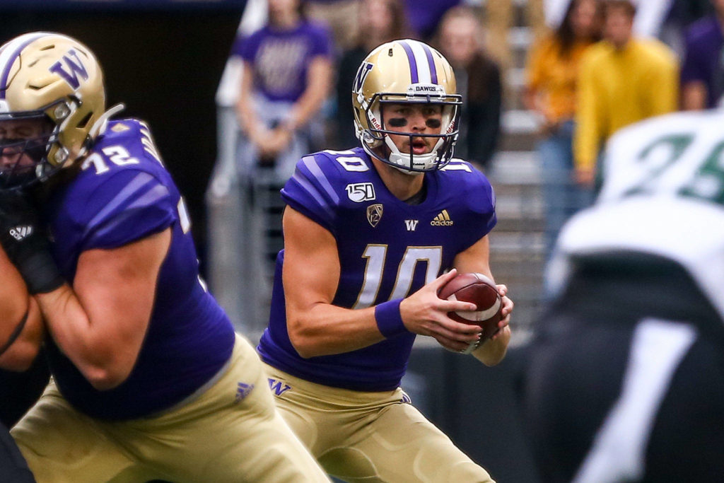 Washington Jacob Eason runs a play from scrimmage Saturday evening at Husky Stadium in Seattle on September 14, 2019. Husky won 52-20. (Kevin Clark / The Herald)
