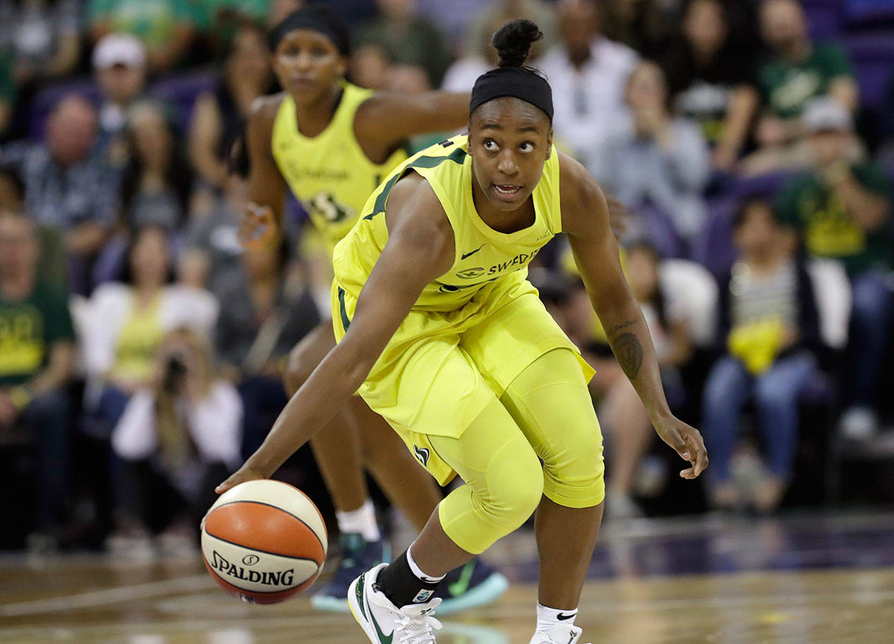 Seattle Storm’s Jewell Loyd brings the ball up against the Las Vegas Aces during the first half of a WNBA basketball game Friday, July 19, 2019, in Seattle. (AP Photo/Elaine Thompson)