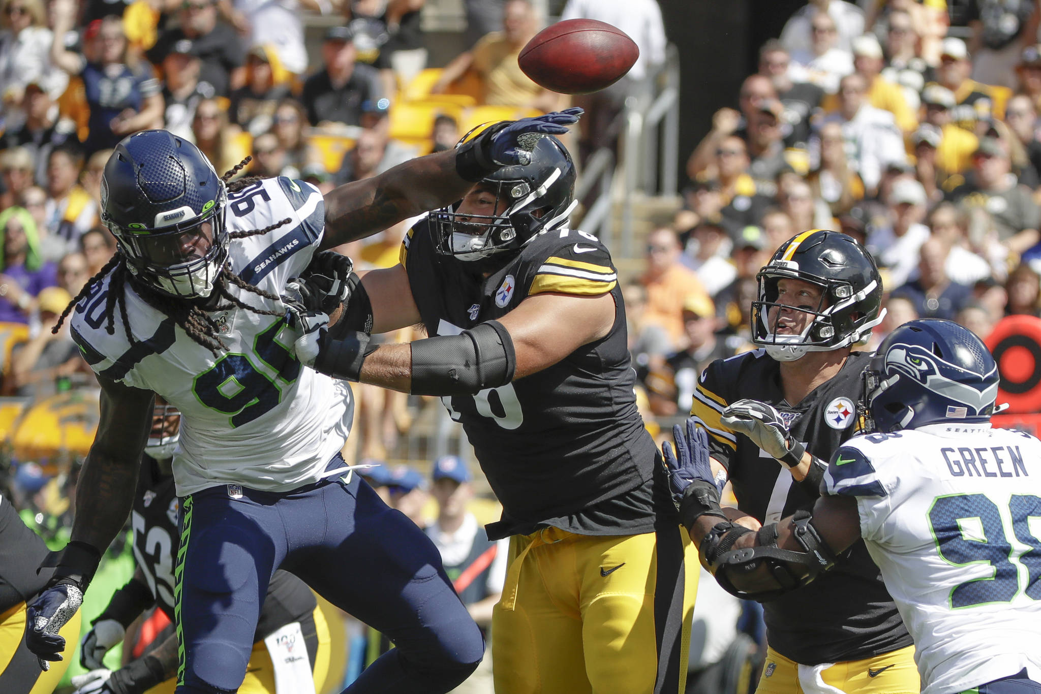 Seattle’s Jadeveon Clowney (90) deflects a pass by Pittsburgh Steelers quarterback Ben Roethlisberger in the first half of Sunday’s NFL game in Pittsburgh. Seattle won, 28-26. (AP Photo/Gene J. Puskar)