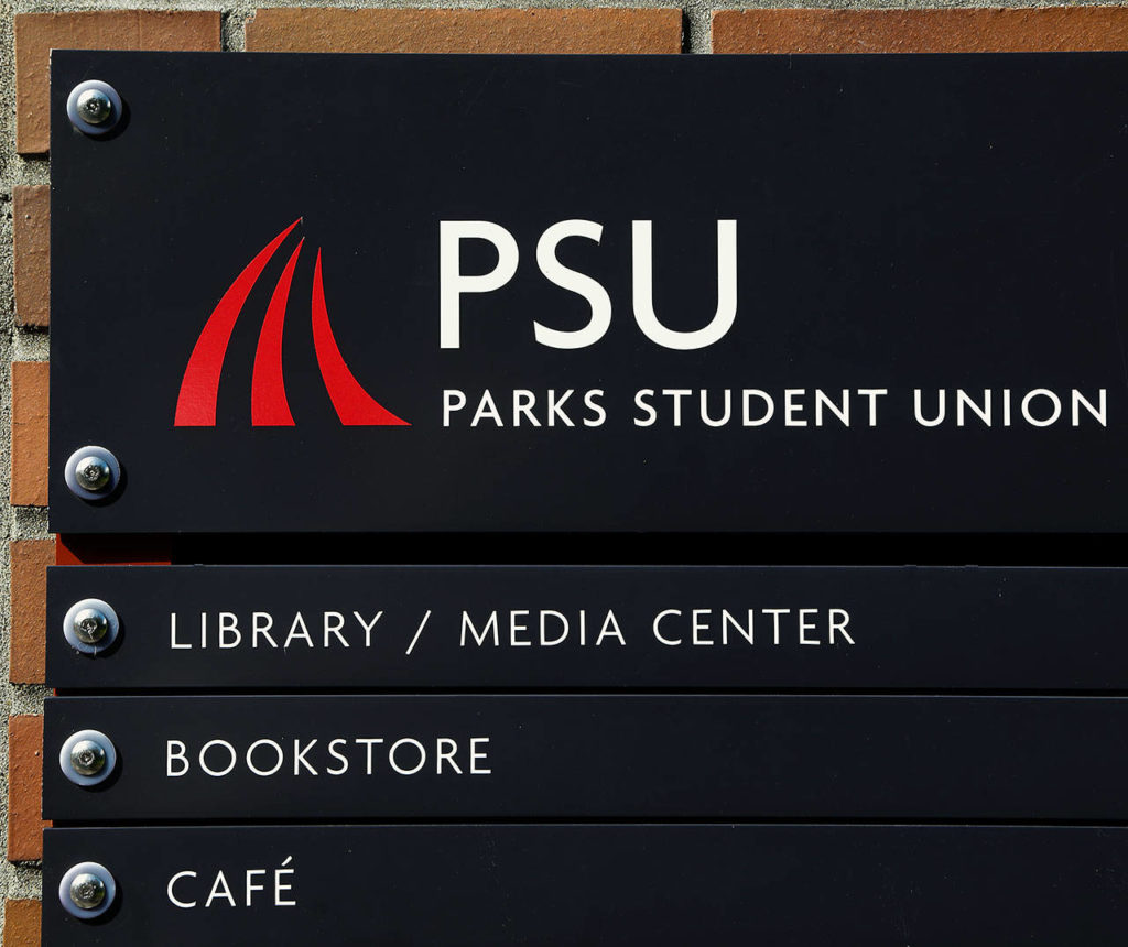 The three red spires seen here at the Parks Student Union building are Everett Community College’s official logo. It can be seen throughout the campus. The design was inspired by “Feather Star,” a stainless steel sculpture that survived a 1987 fire that destroyed the previous student union. (Dan Bates / The Herald)
