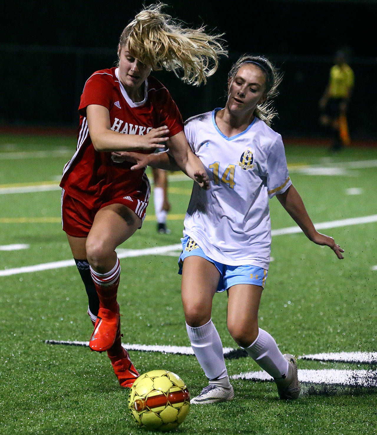 Mountlake Terrace’s Avery Coleman (left) and Everett’s Sydney Sesso battle for control of the ball during a Wesco 3A match Tuesday night at Lynnwood High School in Bothell. (Kevin Clark / The Herald)