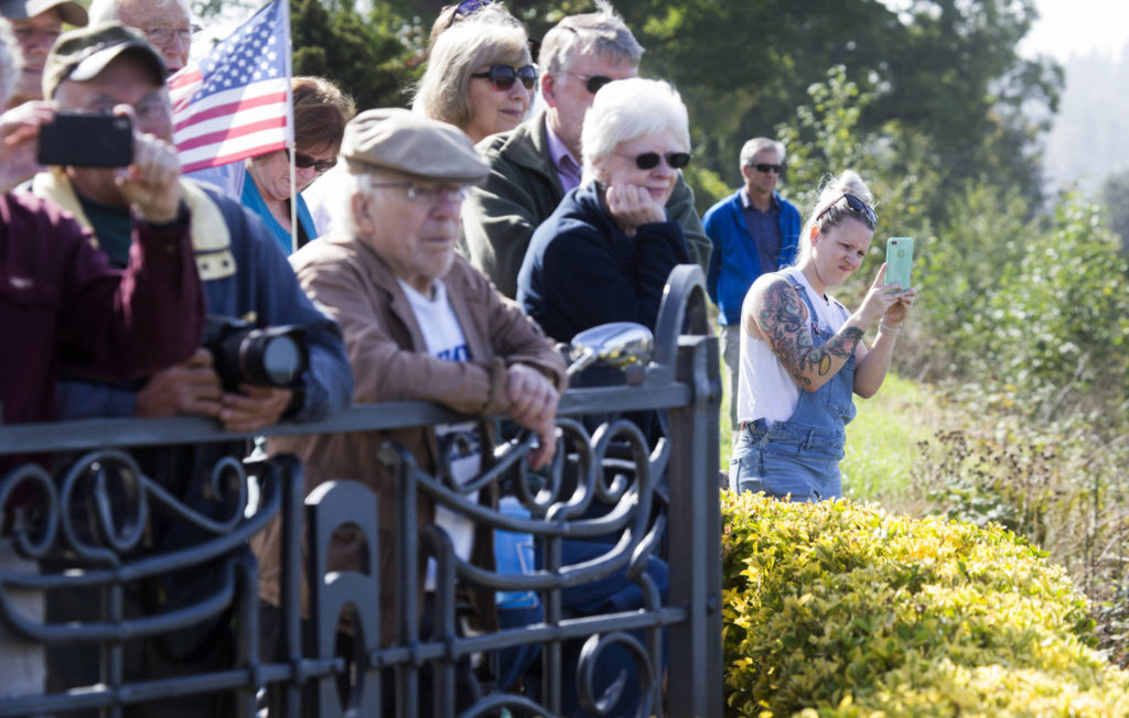 A crowd of people watch the Grand Avenue Park Bridge as it is slowly rotated into place along Marine View Drive on Wednesday in Everett. (Andy Bronson / The Herald)
