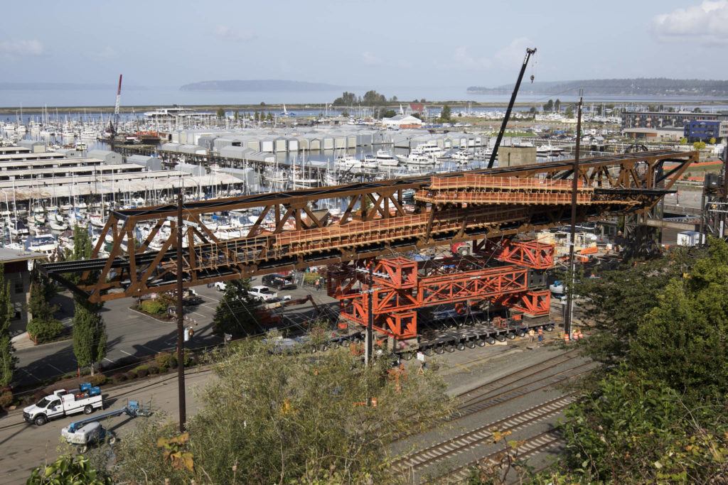 The Grand Avenue Park Bridge is slowly rotated between power poles Wednesday. (Andy Bronson / The Herald)
