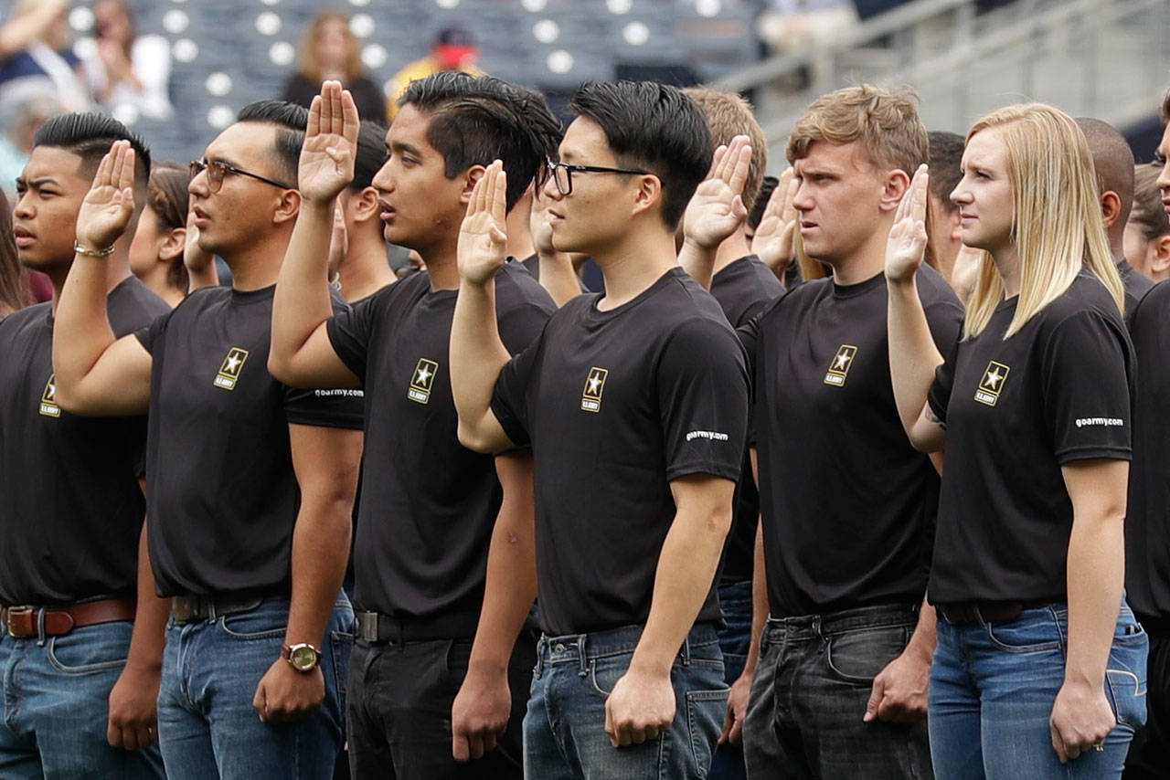 New Army recruits take part in a swearing in ceremony before a baseball game between the San Diego Padres and the Colorado Rockies in San Diego on June 4, 2017. A year after failing to meet its enlistment goal for the first time in 13 years, the U.S. Army is now on track to meet a lower 2019 target after revamping its recruitment effort. (AP Photo/Gregory Bull, File)