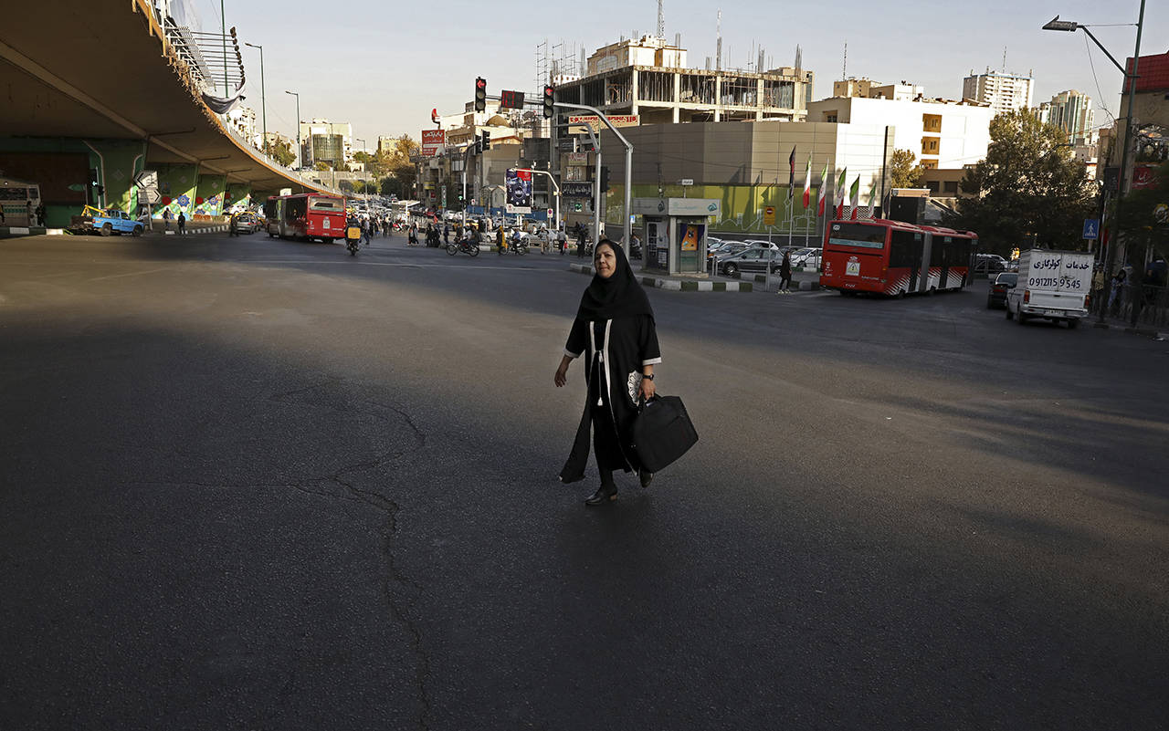 A woman crosses an intersection in northern Tehran, Iran, on Monday. (AP Photo/Vahid Salemi)
