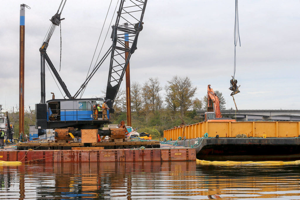 Scrap metal is loaded onto a barge. Removal of the Midas should be complete by early next week. (Kevin Clark / The Herald)
