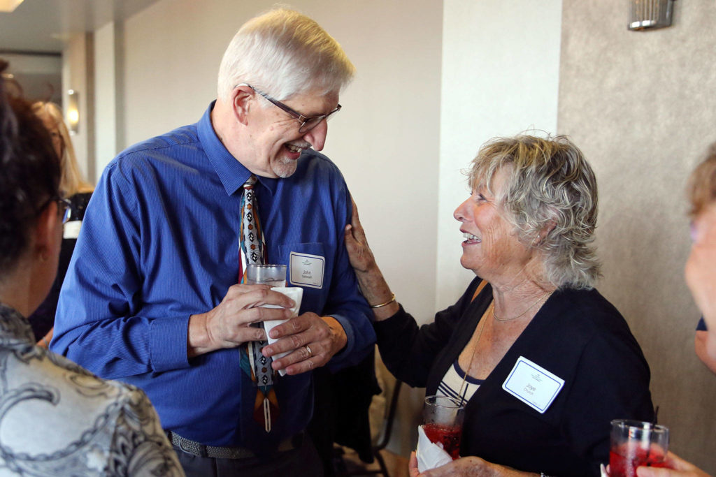 John Galbreath (left) and Joye Church share a laugh during the 10th Annual Snohomish County Sports Hall of Fame Banquet Wednesday evening at Angel of the Winds Arena in Everett. (Kevin Clark / The Herald)
