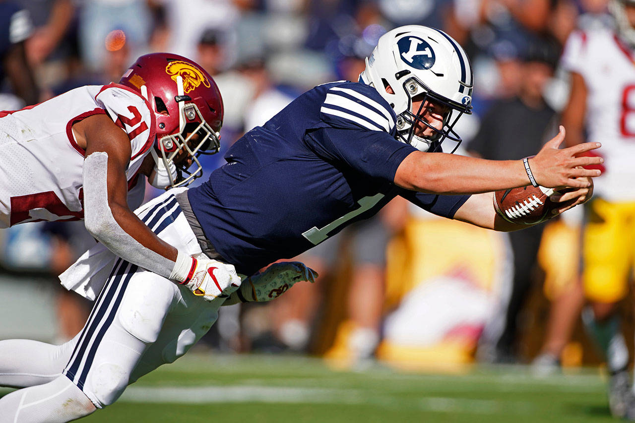 BYU quarterback Zach Wilson (1) dives into the end zone for a touchdown late in the second half as USC safety Isaiah Pola-Mao (21) tries to tackle him during a game Sept. 14, 2019, in Provo, Utah. (AP Photo/George Frey)