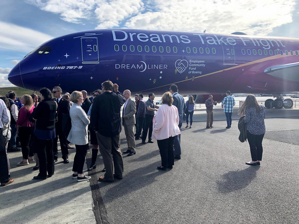 Boeing decorated a 787 Dreamliner to celebrate its Employees Community Fund. Signs and symbols of giving are displayed on a pink and purple decal that’s applied like wallpaper to the airplane. The decal is specifically designed to adhere to the 787 Dreamliner, nearly half of which is made of composite materials. (Janice Podsada / The Herald)
