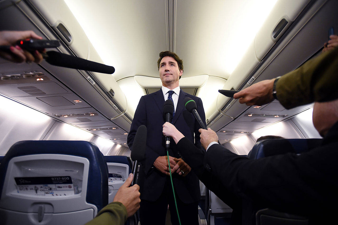 Canadian Prime Minister and Liberal Party leader Justin Trudeau makes a statement Wednesday in regards to a photo coming to light of himself from 2001, wearing “brownface,” during a scrum on his campaign plane in Halifax, Nova Scotia. (Sean Kilpatrick/The Canadian Press via AP)
