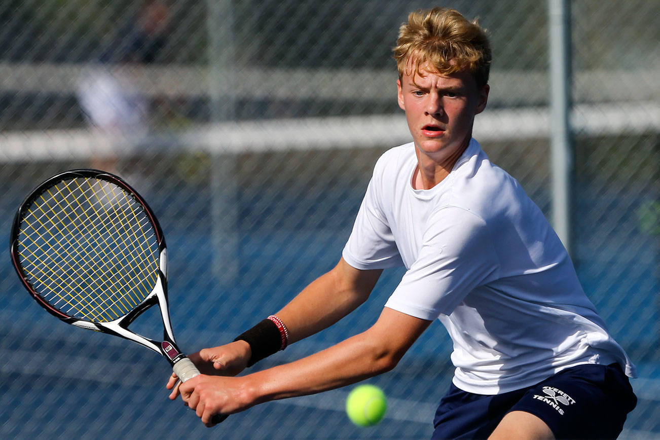 Everett’s Aaron Robertson returns volley against Arlington at Clark Park in Everett on September 19, 2019. (Kevin Clark / The Herald)