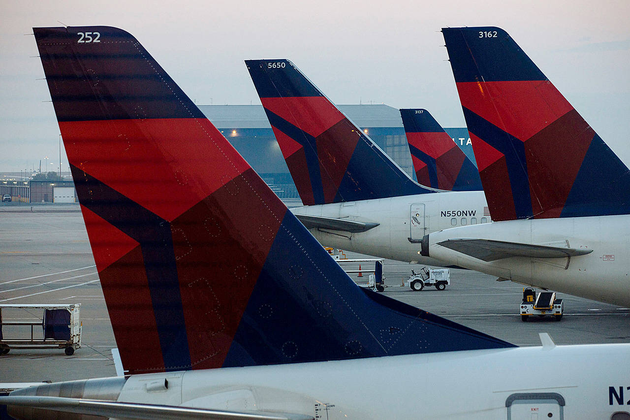 Delta Air Lines planes sit at a gate at Salt Lake City International Airport. (Bloomberg photo)