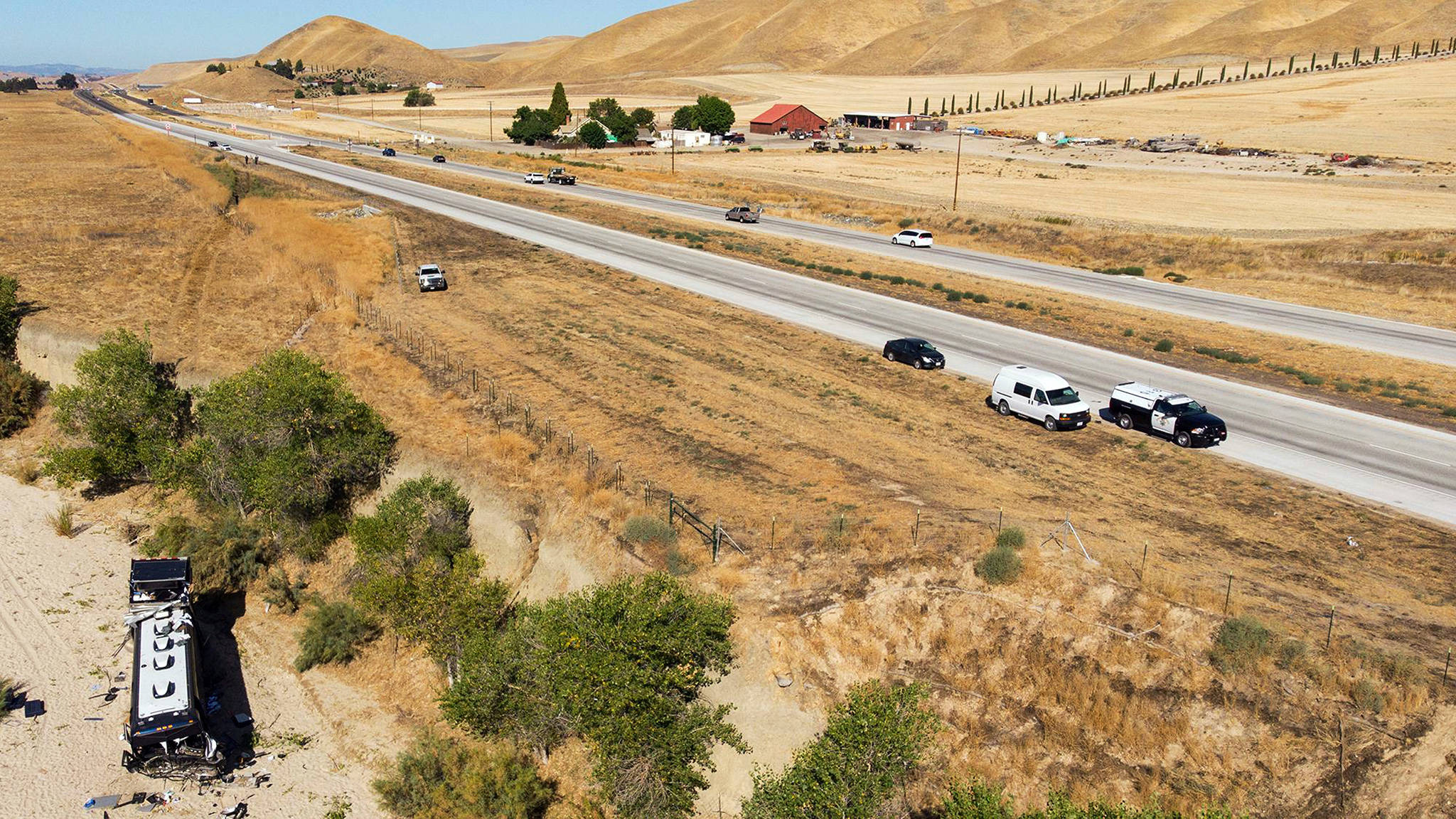 A wrecked tour bus sits in a dry river bed on Highway 46 near Shandon in Cailfornia’s Central Coast region Thursday. The bus, carrying the road crew for country singer Josh Turner, crashed Wednesday evening, leaving one dead and seven injured, Turner and his band were not on the bus. Two of the passengers are said to have sustained major injuries and five had moderate injuries. (David Middlecamp / The Tribune)