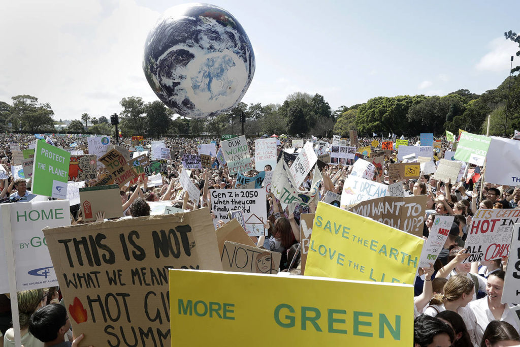 A large inflatable globe is bounced through the crowd as thousands of protestors, many of them school students, gather in Sydney, Australia, on Friday, calling for action to guard against climate change. (AP Photo/Rick Rycroft)
