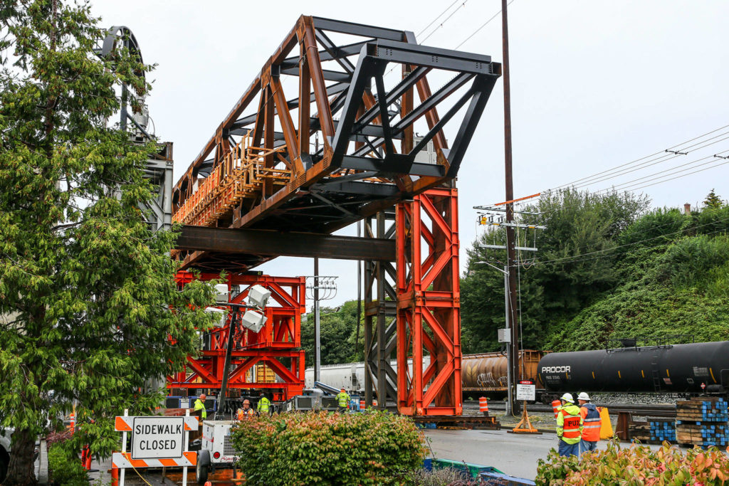 Work continues Monday in Everett on the Grand Avenue Bridge in preparation for the move later this week. (Kevin Clark / The Herald)
