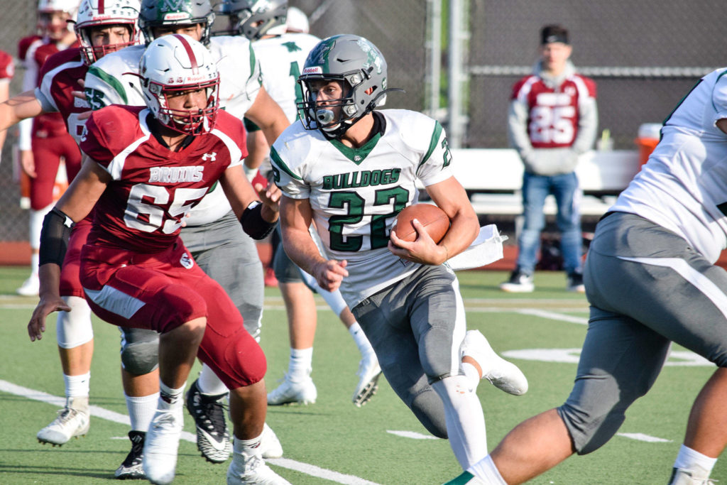 Senior running back Trevor Beaner runs through the Cascade defense on Friday, Sept. 20 at Everett Memorial Stadium. (Katie Webber / The Herald)
