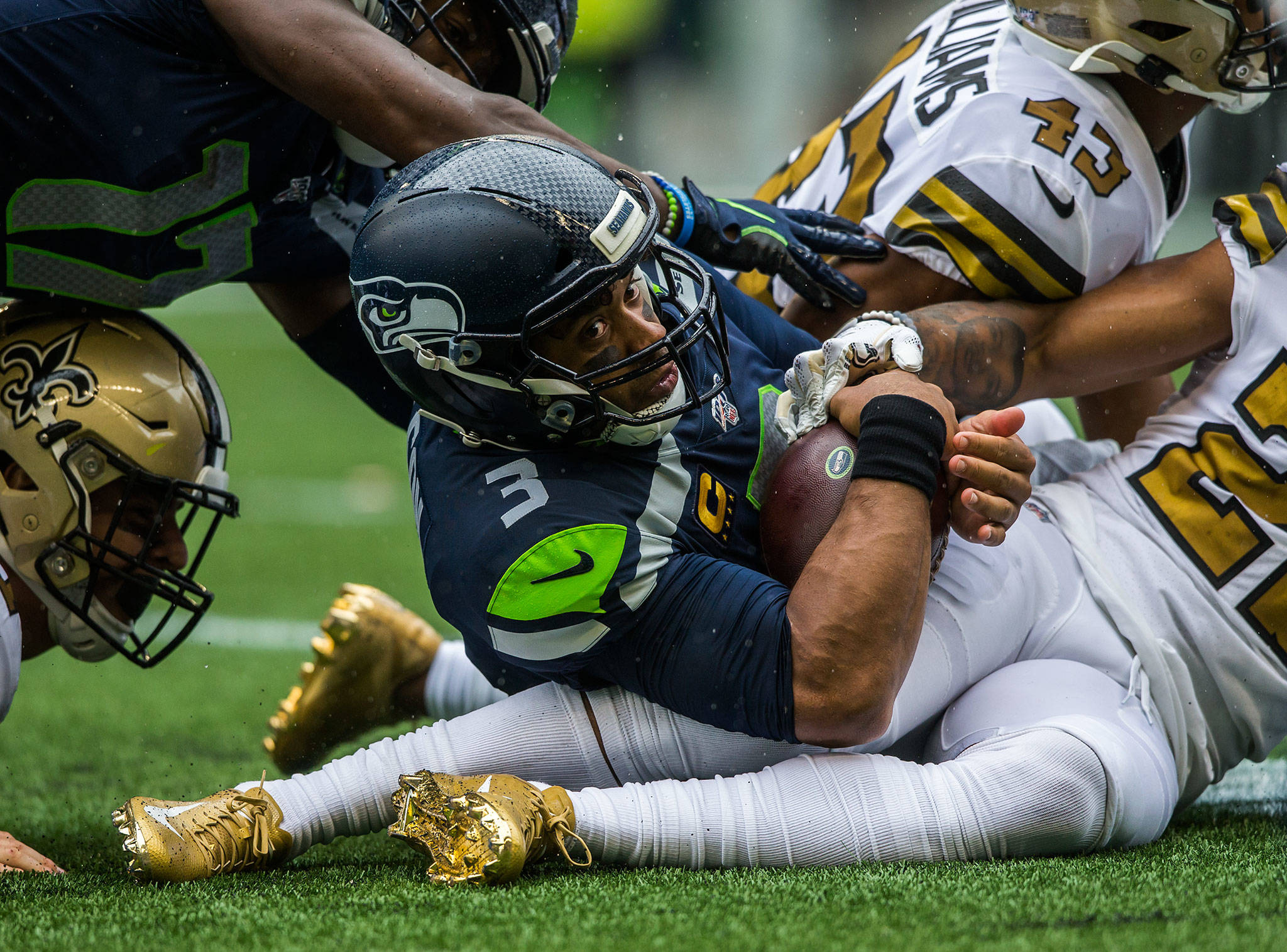 Seattle’s Russell Wilson looks to the sideline to see if he got a first down after running the ball Sunday during the game against the New Orleans Saints at CenturyLink Field in Seattle. (Olivia Vanni / The Herald)