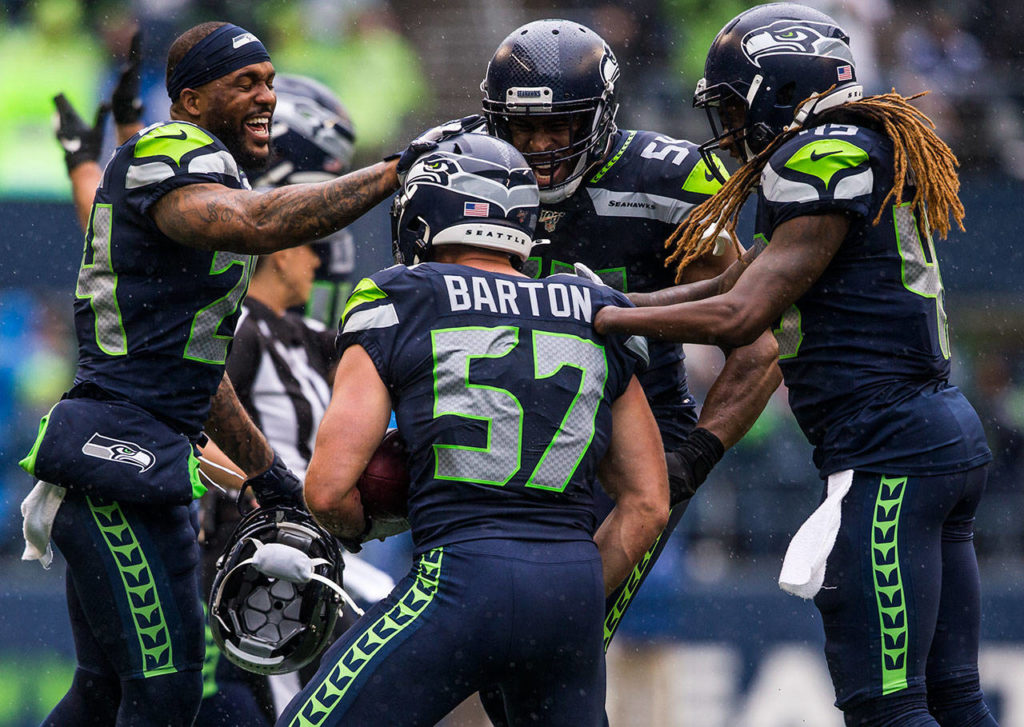Seahawks celebrate with Seattle’s Cody Barton after he recovers a fumble Sunday during the game against the New Orleans Saints at CenturyLink Field in Seattle. (Olivia Vanni / The Herald)
