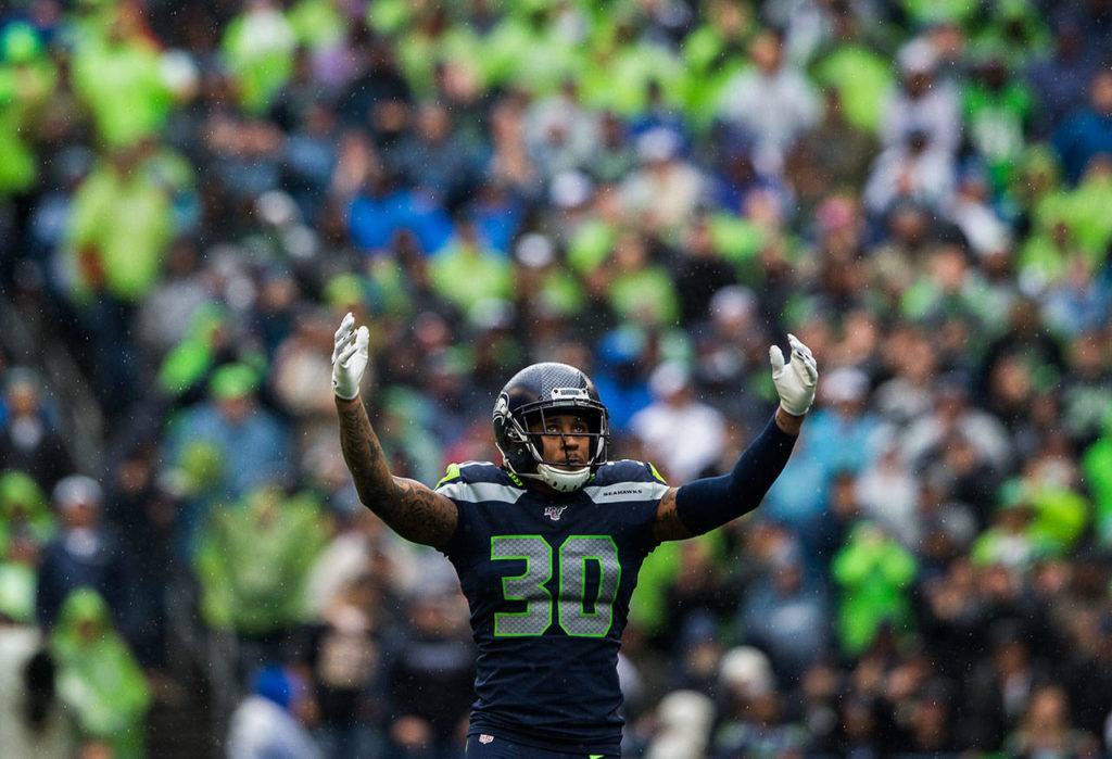 Seattle’s Bradley McDougald waves his arms to get the crowd to make noise Sunday during the game against the New Orleans Saints at CenturyLink Field in Seattle. (Olivia Vanni / The Herald)

