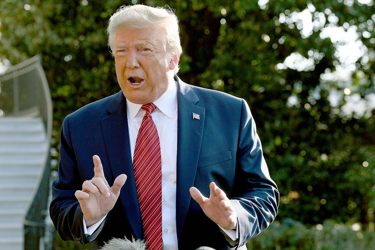 President Donald Trump talks with reporters before leaving on Marine One from the South Lawn of the White House in Washington on Sunday. (AP Photo/Susan Walsh)