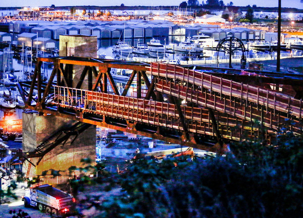 At last, the $20 million pedestrian bridge was in place spanning West Marine View Drive by late Wednesday after sunset. (Dan Bates / The Herald)
