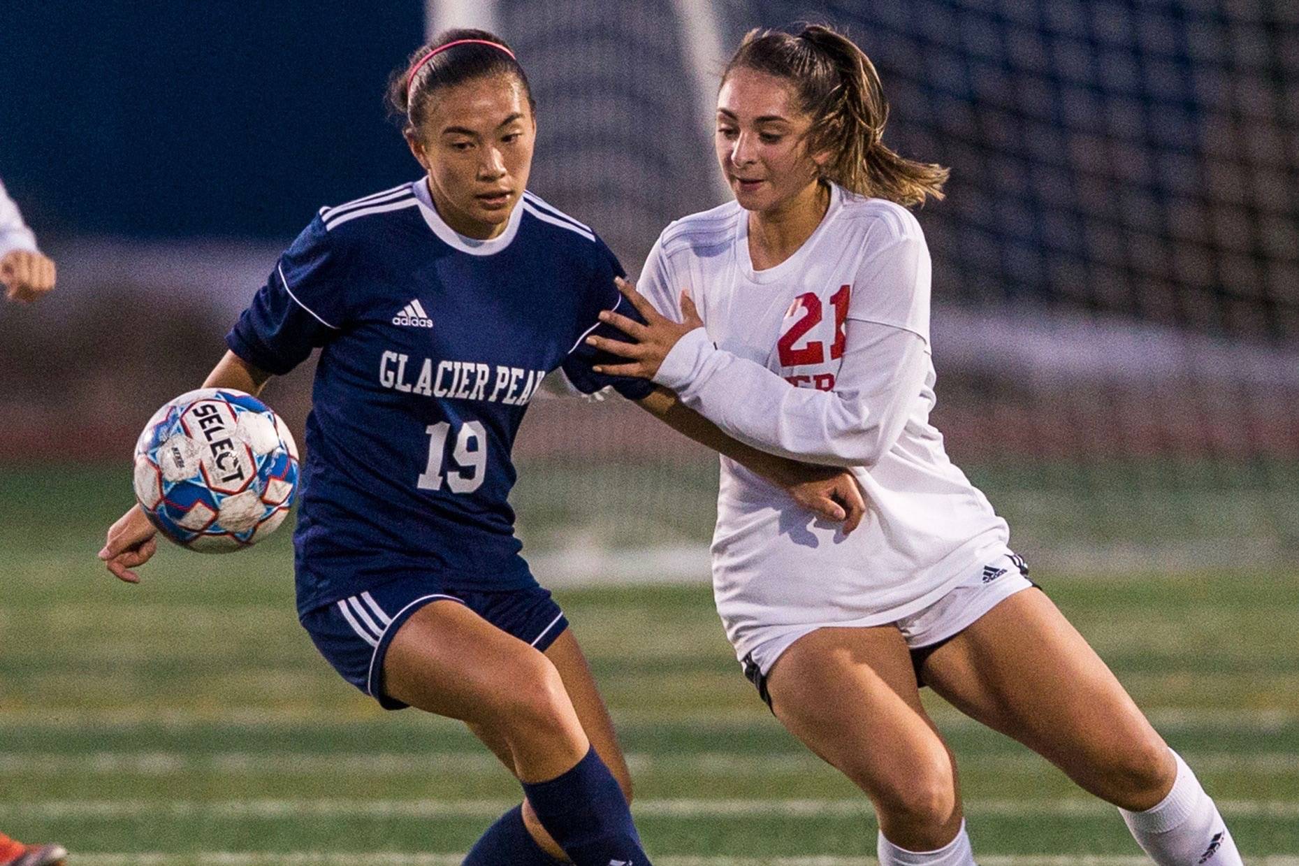Emily Strong (left) and Glacier Peak host perennial power Jackson in a pivotal Wesco 4A girls soccer match Tuesday night. (Olivia Vanni / The Herald)