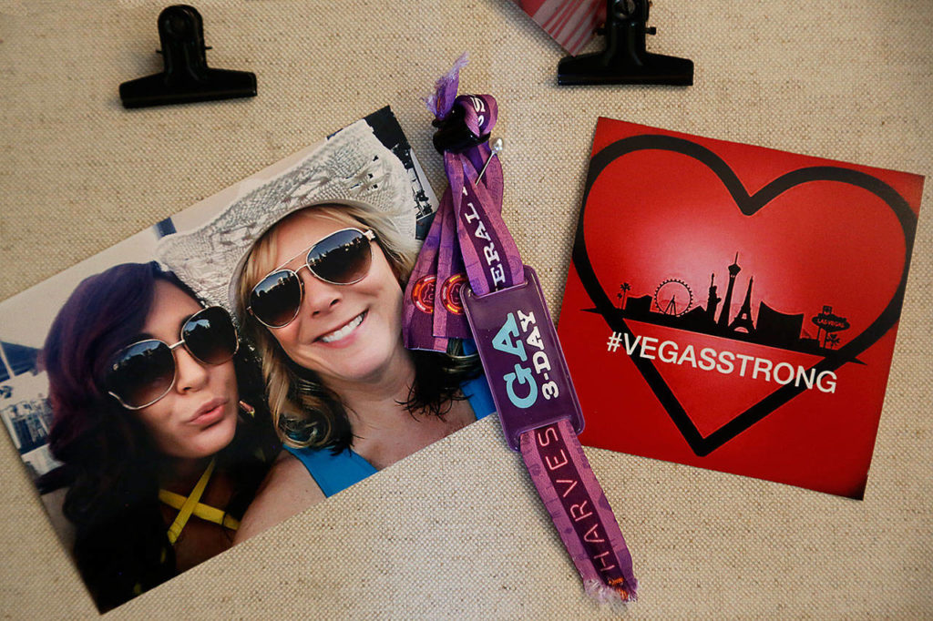 Susan Zahler (right) and her daughter Alicia Lochrie in a snapshot taken at a 2017 country-music festival in Las Vegas before a gunman killed 58 people there. Other mementos include their concert wristbands and a tribute to the grieving community. (Dan Bates / The Herald
