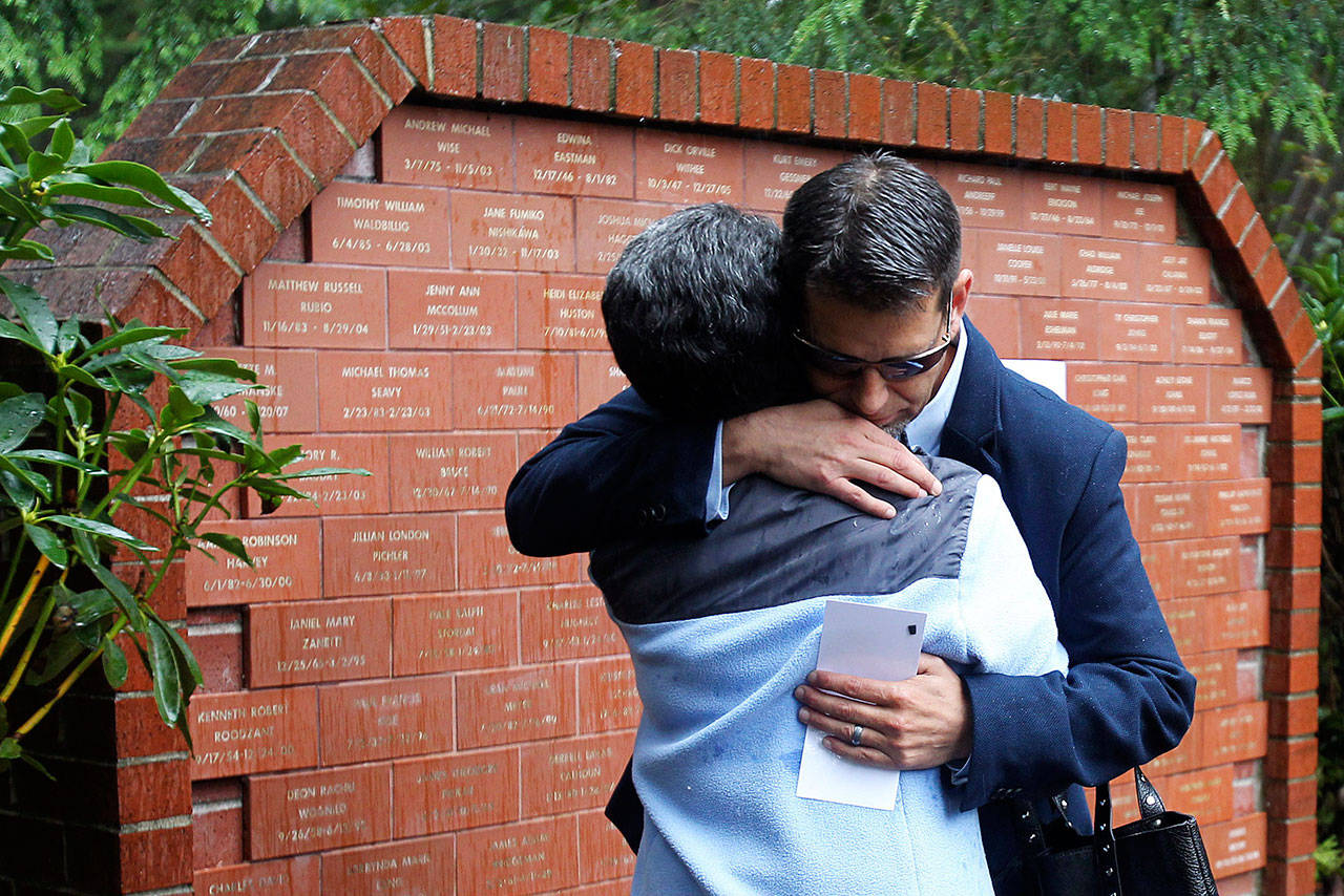 James Snow hugs his mother, Ruth Perin, on Sept. 17, 2015, after unveiling a tile in honor of his brother, Peter John Snow, who was killed by a drunk driver in 1994. (Genna Martin / Herald file)