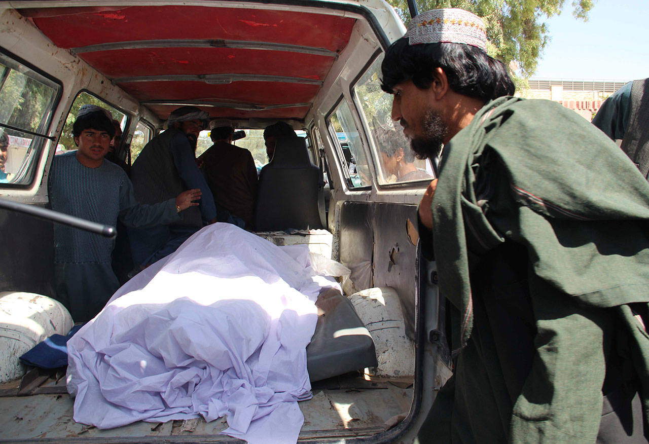 Afghans transport the body of a woman who was killed during a raid Monday conducted by Afghan special forces in the southern Helmand province. An Afghan official said Monday that at least 40 civilians have been killed during an Afghan special forces raid and airstrikes conducted against of Taliban in southern Helmand province. (AP Photo/Abdul Hadi)