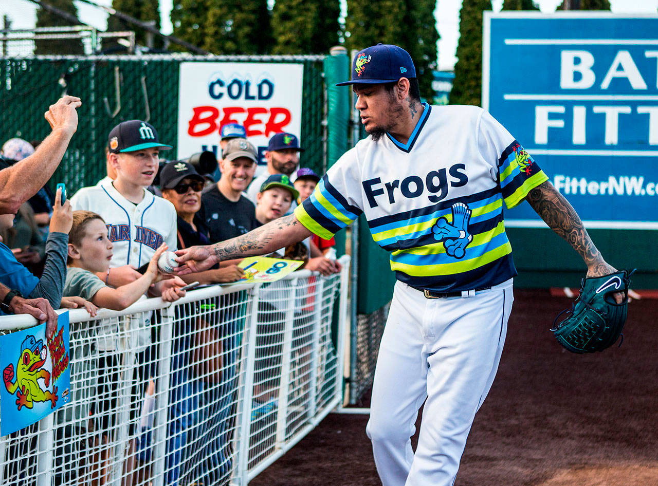 Mariners pitcher Felix Hernandez gives a ball to a fan before a rehab appearance Aug. 14 at Funko Field in Everett. (Olivia Vanni | The Herald)