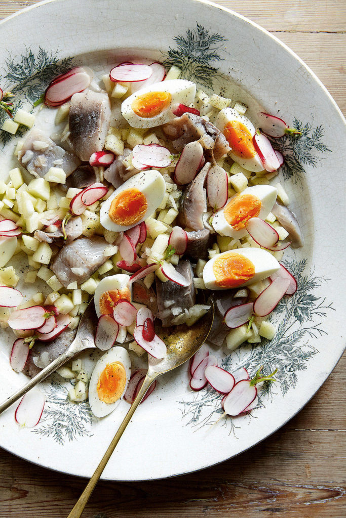 This simple salad is made with brined herring, tart green apple, sliced radishes and quartered eggs. (Ola O. Smit)
