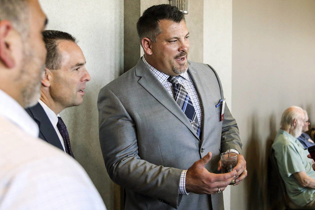 Jarred Rome talks with attendees during the 10th Annual Snohomish County Sports Hall of Fame Banquet at Angel of the Winds Arena in Everett on Sept. 18. (Kevin Clark / The Herald)
