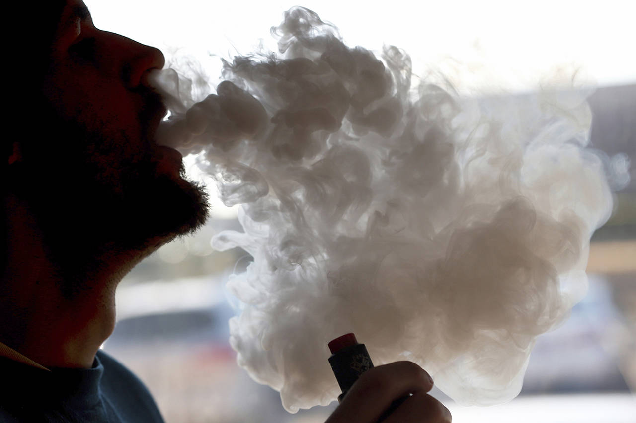In this Jan. 18 photo, a man exhales a puff of smoke from a vape pipe at a shop in Richmond, Virginia. (AP Photo/Steve Helber)