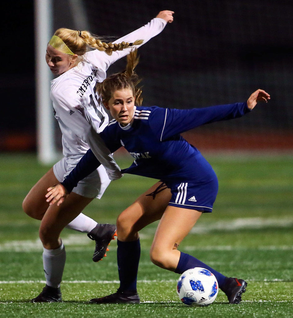 Jackson’s Ella Weidle (left) struggles with Glacier Peak’s Ryann Reynolds for control Tuesday night at Glacier Peak High School in Snohomish on September 24, 2019. Glacier Peak won 5-1. (Kevin Clark / The Herald)
