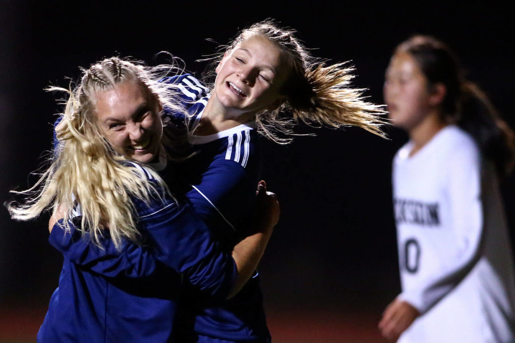 Glacier Peak’s’ Annika Lambott and Chloe Seelhoff celebrate Lambott’s goal in the second half Tuesday night at Glacier Peak High School in Snohomish on September 24, 2019. Glacier Peak won 5-1. (Kevin Clark / The Herald)
