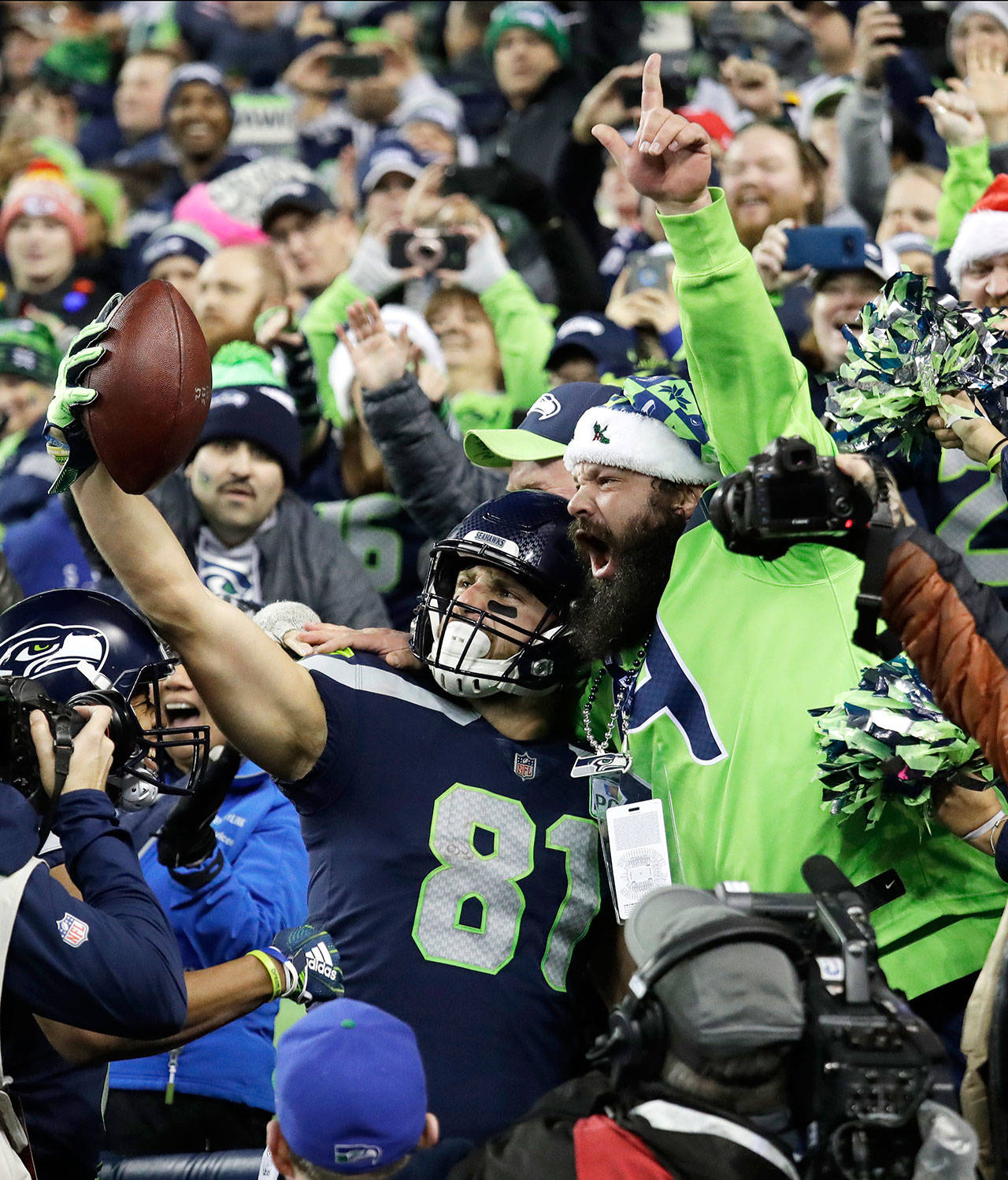 Seattle Seahawks tight end Nick Vannett (81) celebrates with a fan after he scored a touchdown against the Kansas City Chiefs during a game on Dec. 23, 2018, in Seattle. (AP Photo/Elaine Thompson)