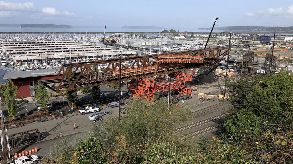Crews (lower right) reinforce the road. (Andy Bronson / The Herald)
