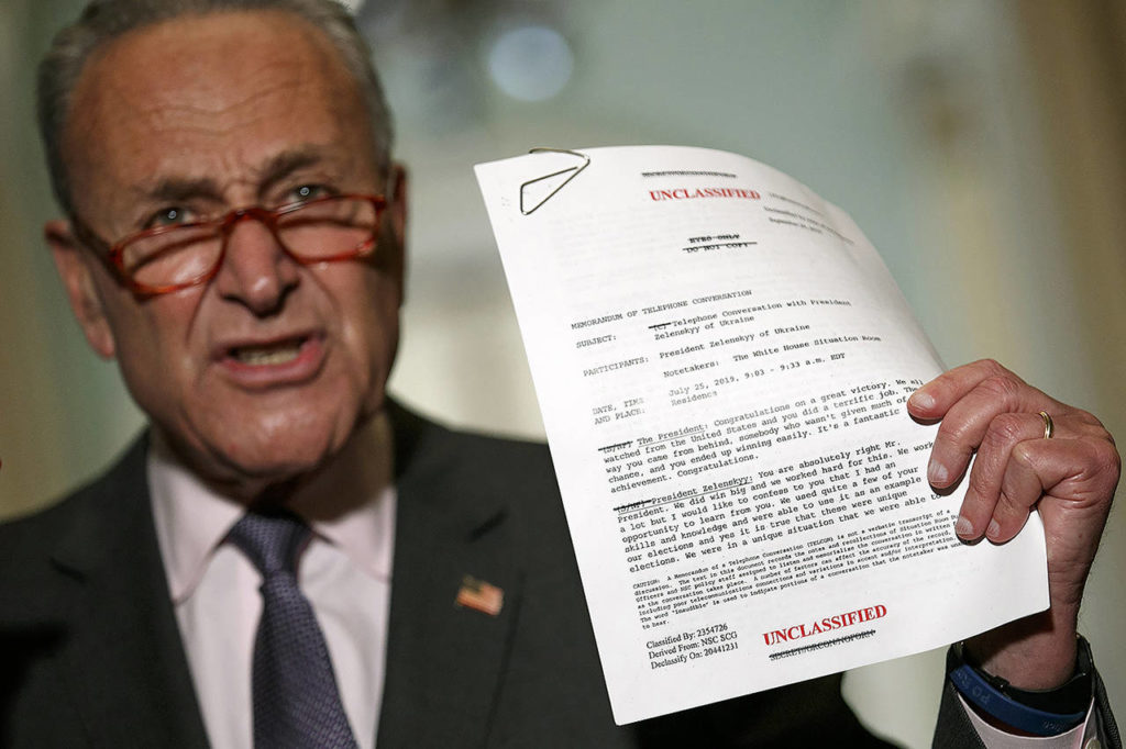 Senate Minority Leader Sen. Chuck Schumer holds up a copy of a White House released rough transcript of a phone call between President Donald Trump and the President of Ukraine on Wednesday in Washington. On Thursday, the House Intelligence Committe released a redacted version of a whistleblower complaint at the center of Democrats’ impeachment probe of President Donald Trump. (AP Photo/Jacquelyn Martin)
