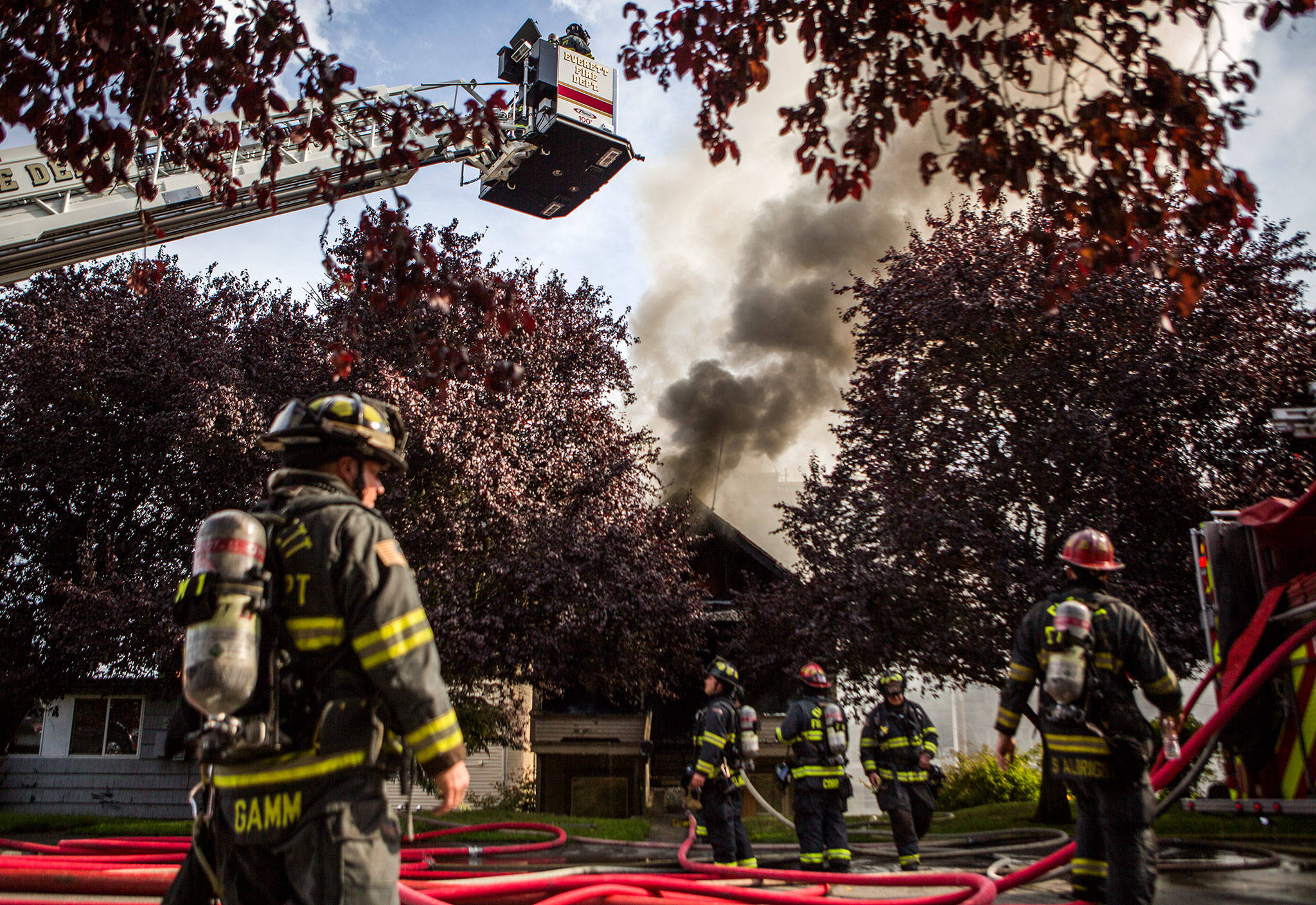 Everett firefighters battle a house fire near Lombard Ave and 32nd Street on Thursday. (Olivia Vanni / The Herald)
