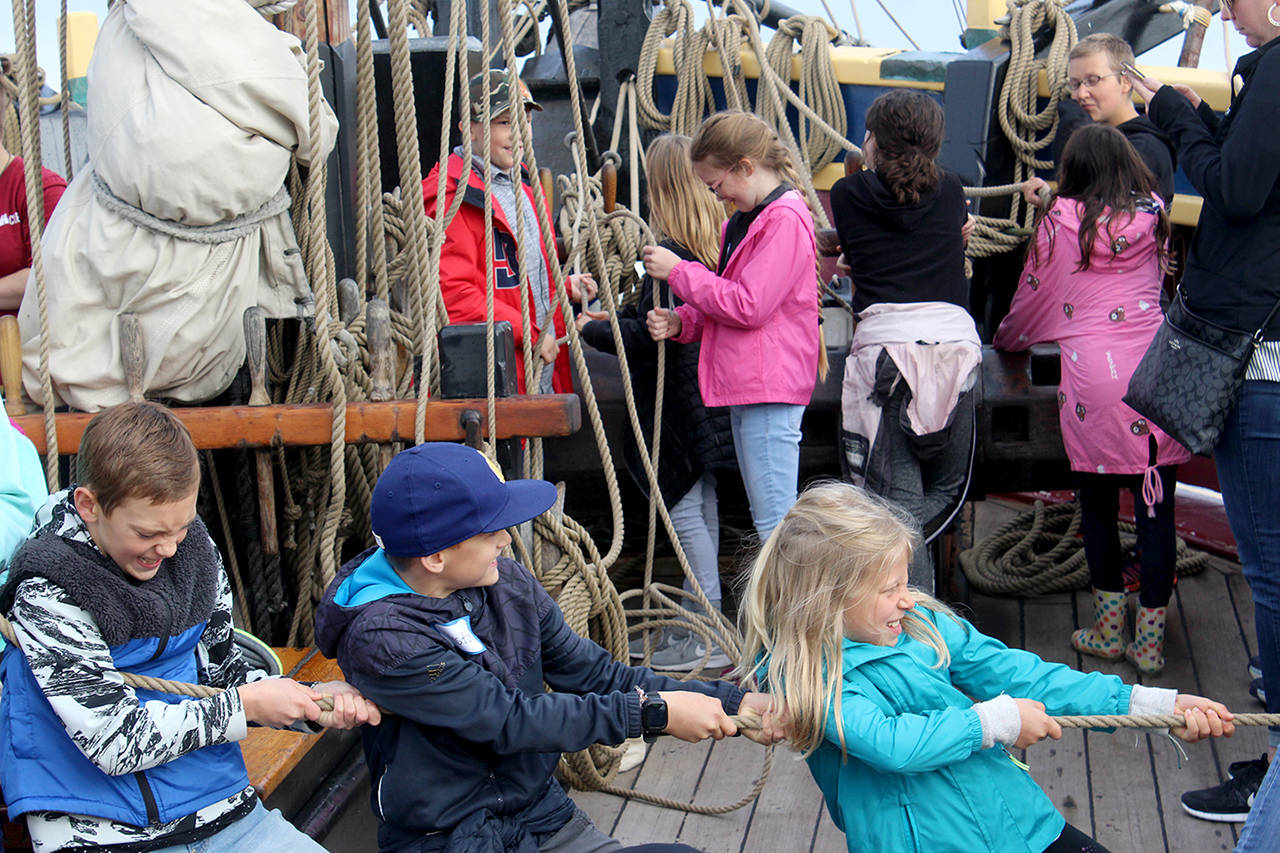 South Whidbey Elementary School students Weston Dill (right) and Taylor Jones (left) pull ropes aboard the Lady Washington historic “tall ship” in Langley harbor on Thursday. (Wendy Leigh / South Whidbey Record)